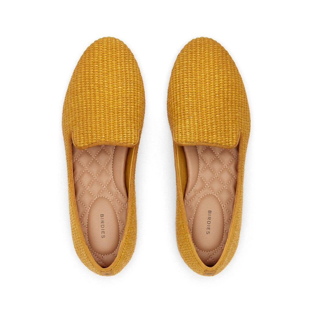 A photo of mustard yellow slip-on shoes by Birdies.